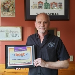 man holding a framed sign